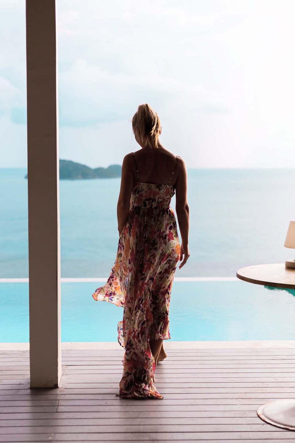 woman-in-flying-summer-dress-at-luxury-hotel-villa-M6J8VZT-1024x1536
